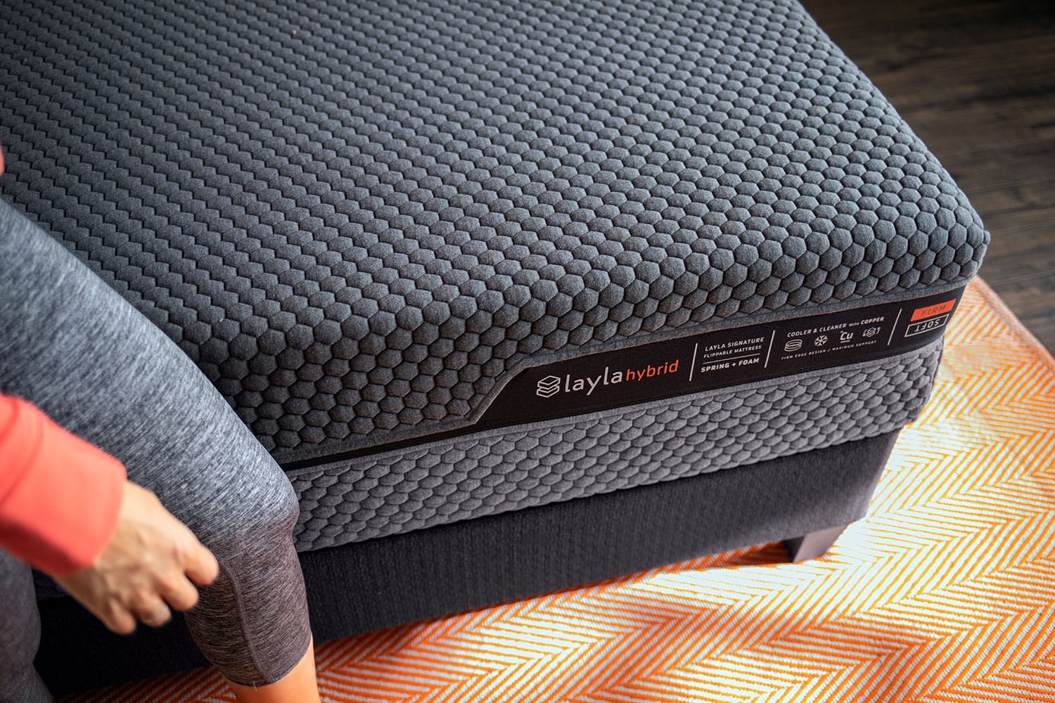 Woman walking next to hybrid mattress