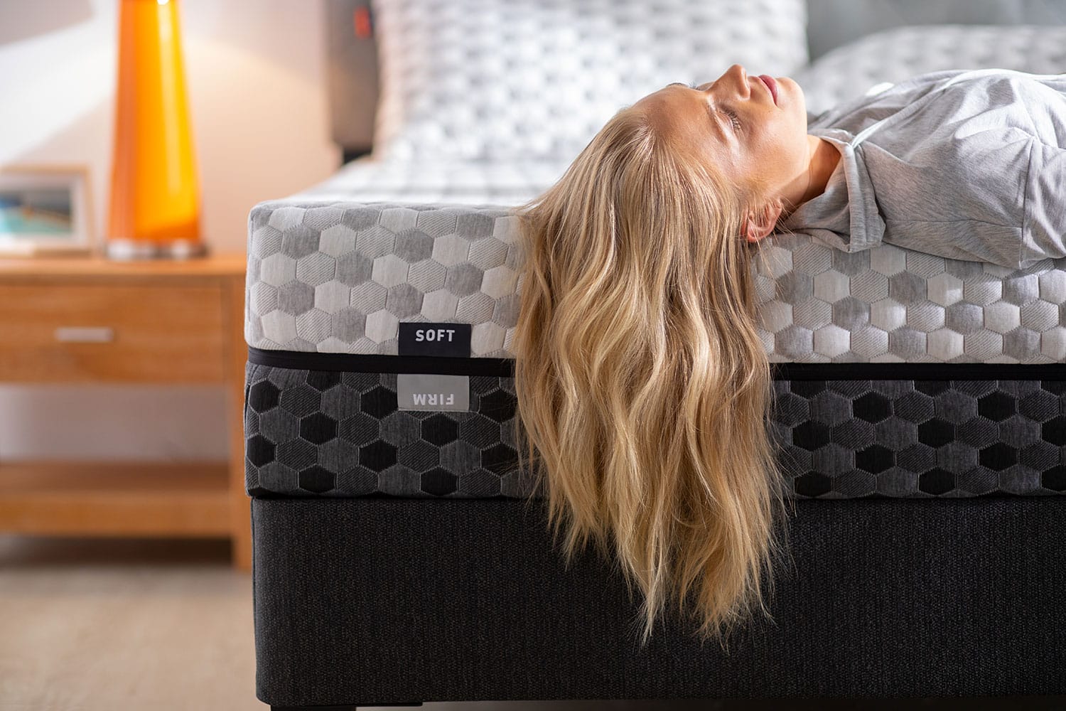 Woman laying on edge of memory foam mattress