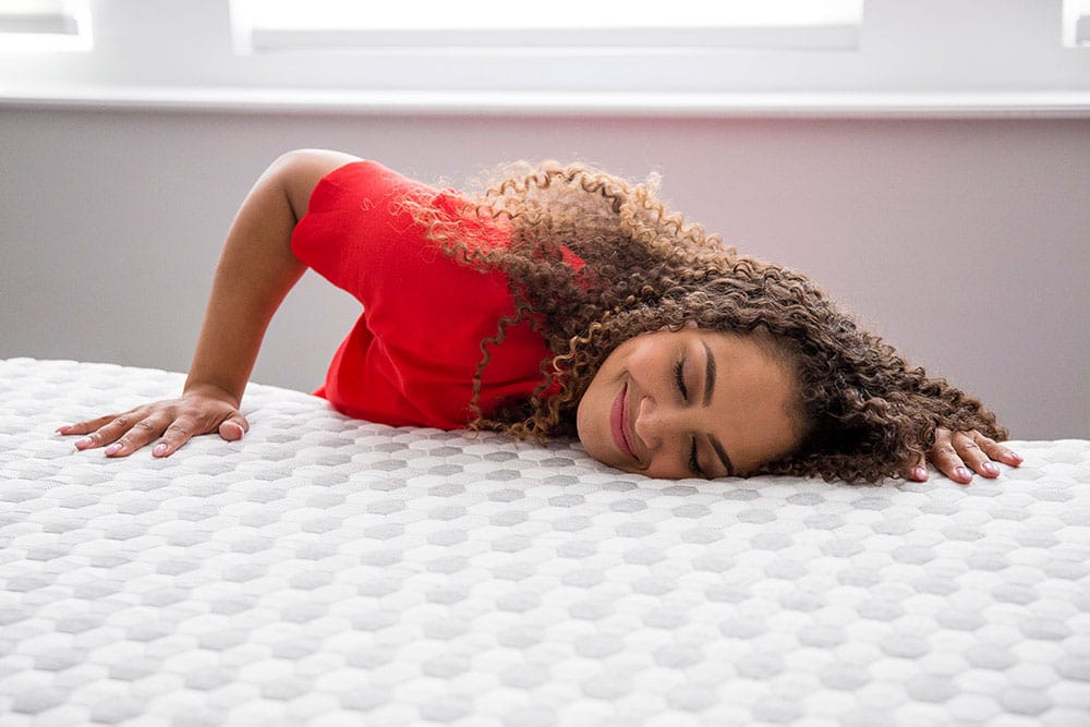 Woman resting her head on memory foam mattress
