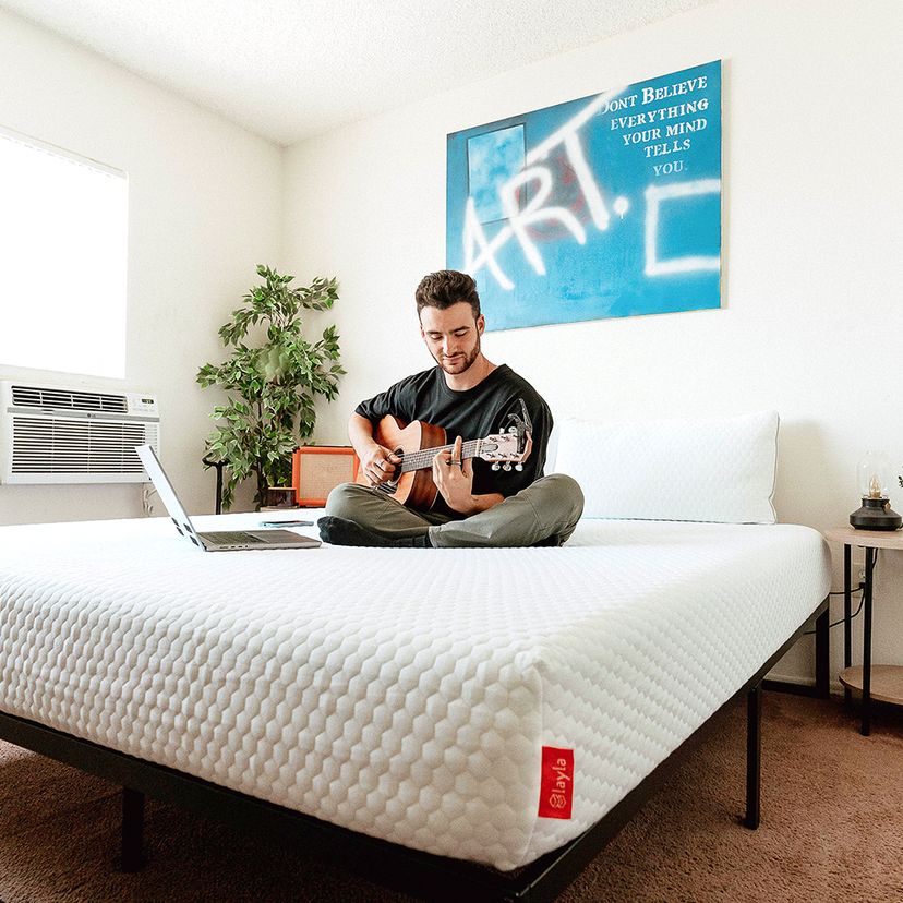 Boy play the guitar on Layla Essential Mattress
