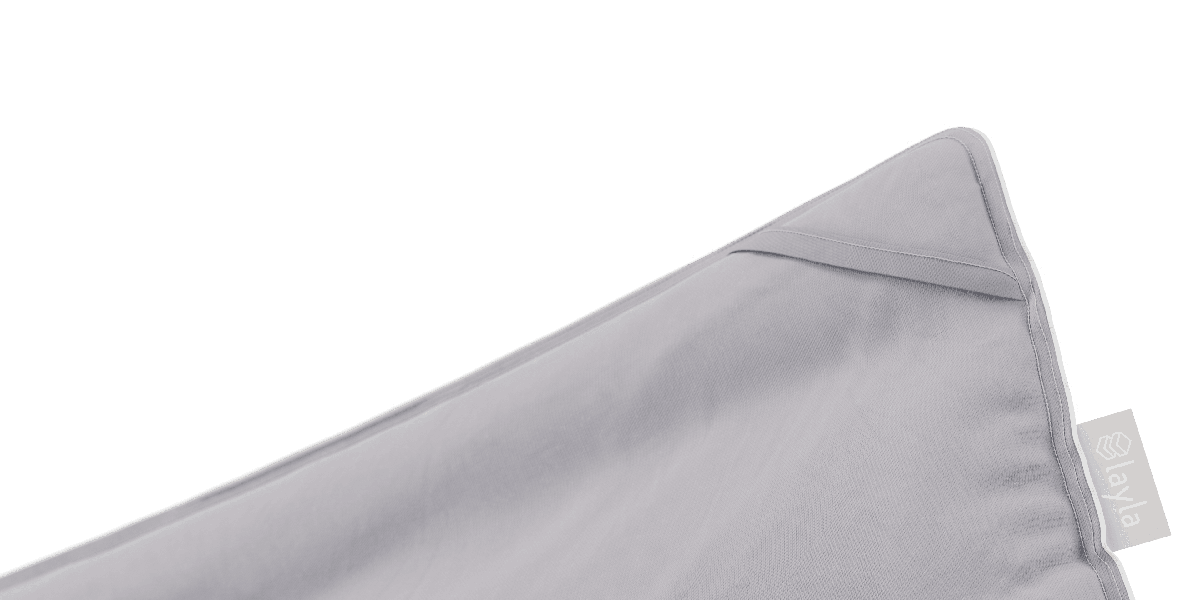 Close up on the corner of a gray comforter